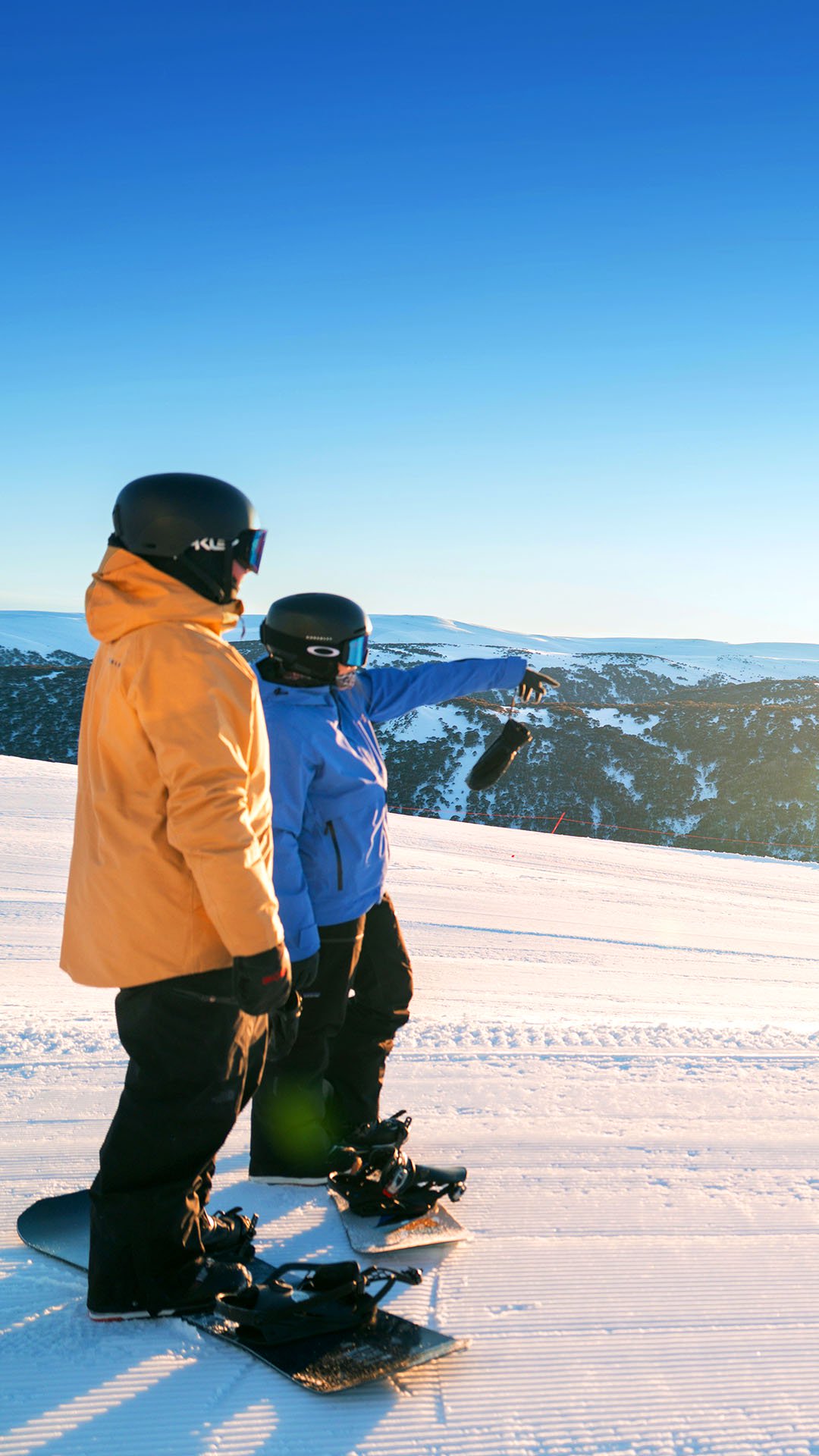Beginner skier linking turns on green terrain with an instructor